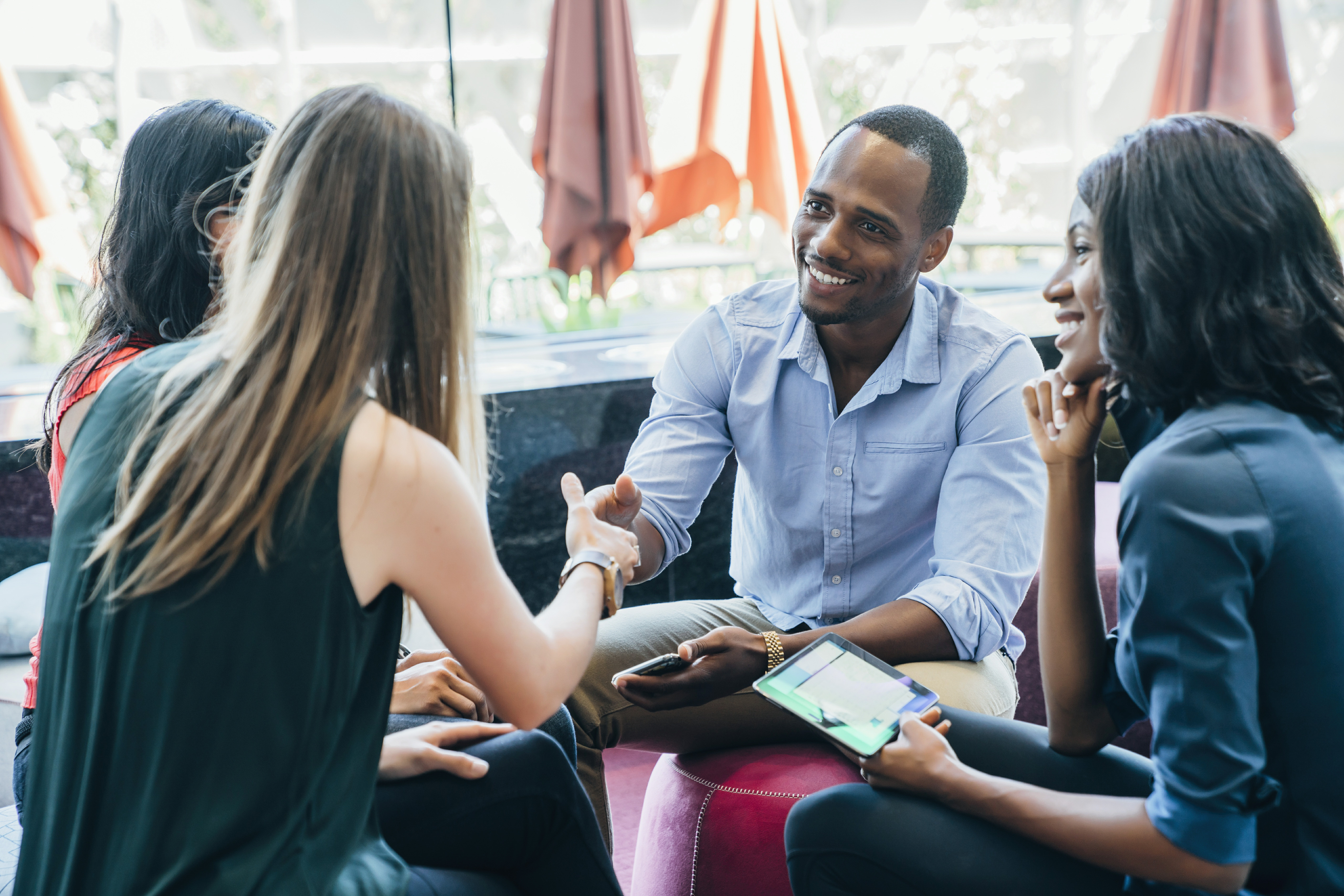 Four people greeting and talking